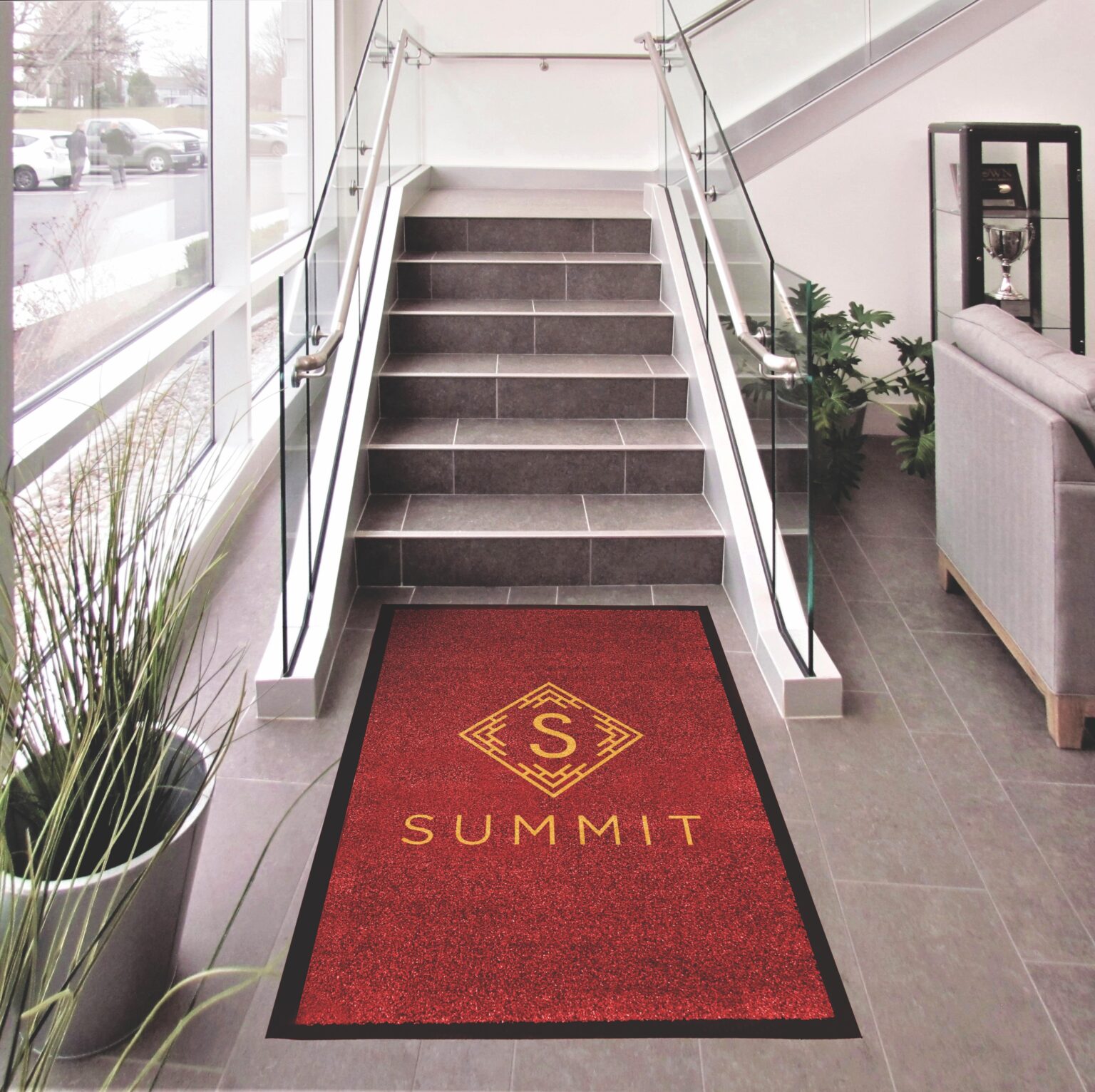 Summit Logo on Red Floor Mat Next to Stairs